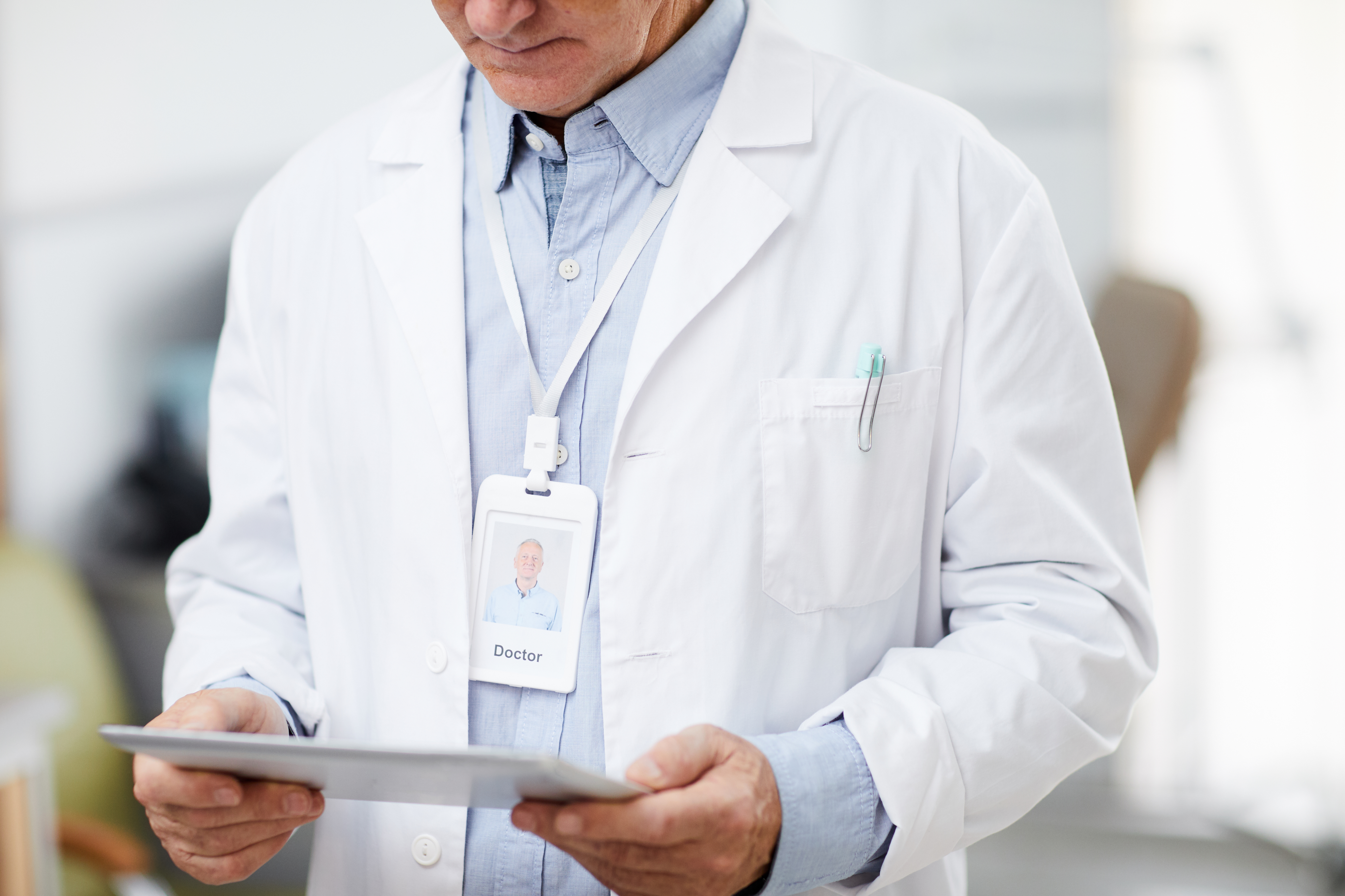 Senior Doctor using Tablet